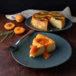 A slice of freshly baked Apricot ricotta thyme cake with a fork resting on the edge.