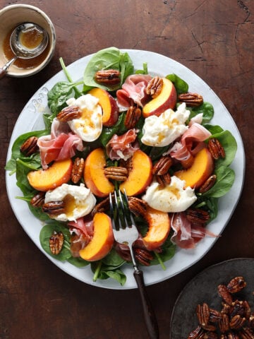Maple balsamic vinaigrette drizzled over a peach burrata prosciutto salad.