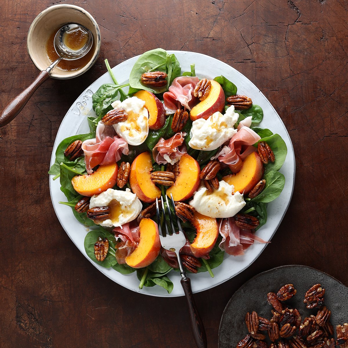 Maple balsamic vinaigrette drizzled over a peach burrata prosciutto salad.