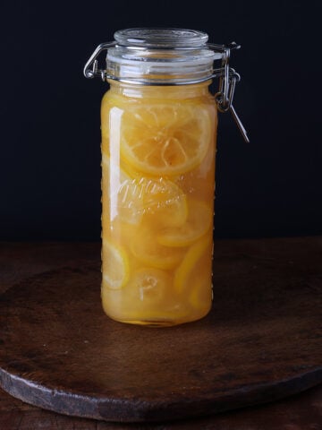 Sealed glass jar of glaceed lemons.