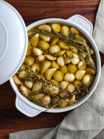 Top view of a baking dish filled with garlic confit.