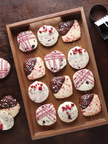 Shortbread cookies baked and decorated with frosting, chocolate and crushed peppermint.