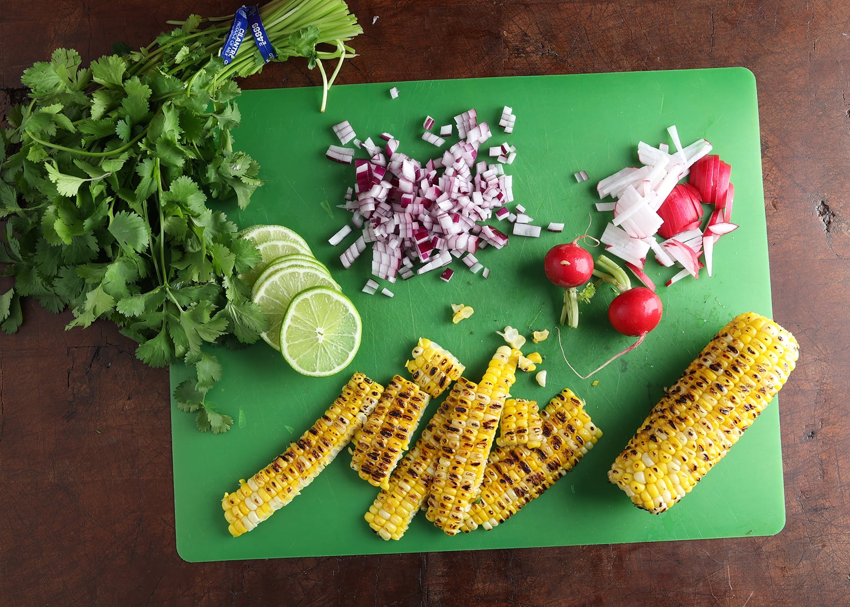 Ingredients shown are used to prepare a southwest lime chicken and rice soup laid out on a cutting board.