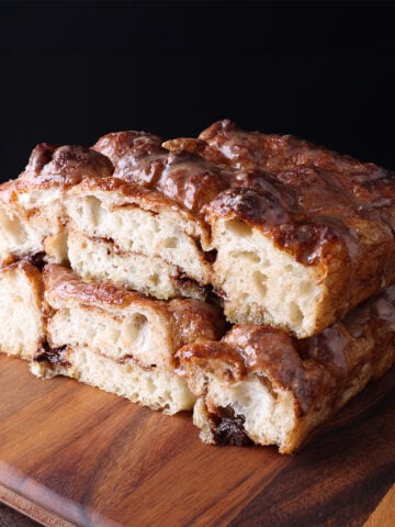 Brown butter chai focaccia slices stacked on top of each other, showing the soft baked bread.
