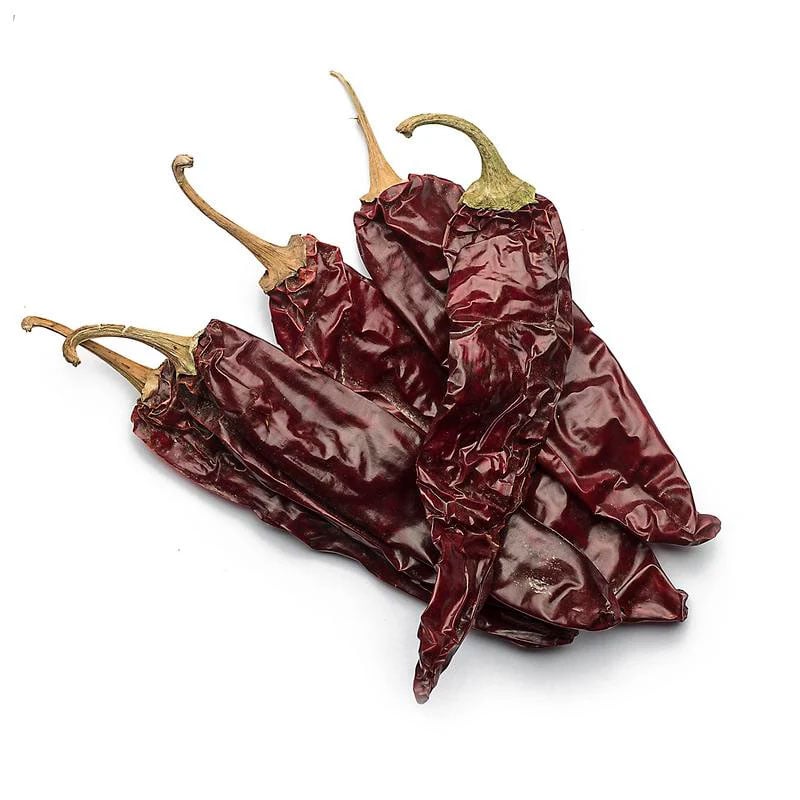 dried paprika pods on white background