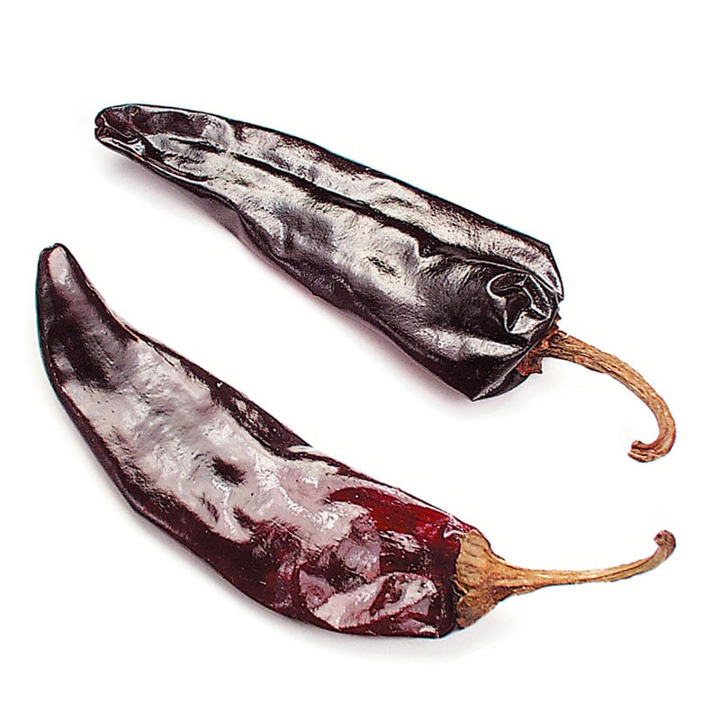 dried guajillo chile known as mirasol when fresh on white background