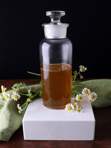Close up of golden chamomile syrup.