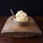 A couple scoops of creamy garlic confit butter served in a bowl.