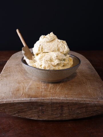 A couple scoops of creamy garlic confit butter served in a bowl.