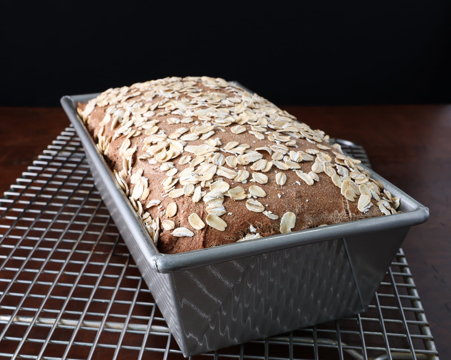 Honey Molasses Brown Bread baked in bake pan on cooling rack