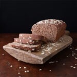 Honey Molasses Brown Bread on cutting board sliced - square photo