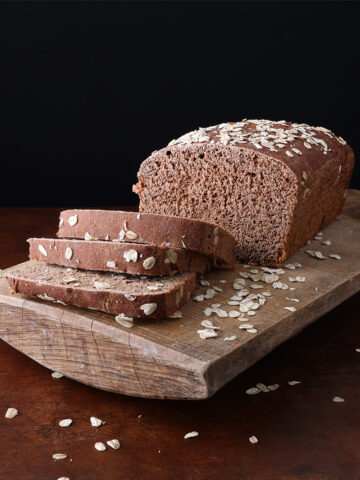 Honey Molasses Brown Bread on cutting board sliced - square photo