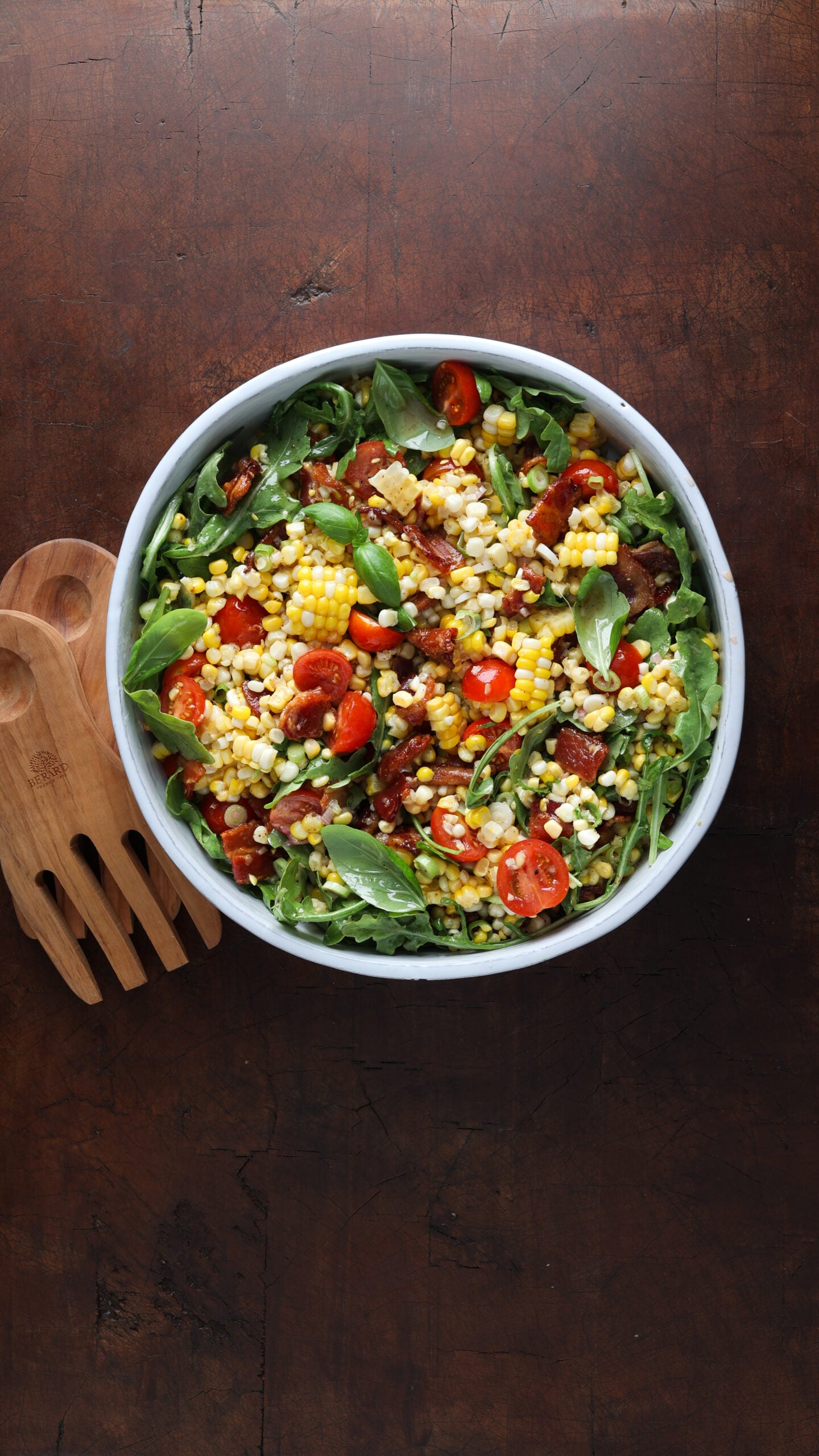 BLT corn salad combined and served in a large circular bowl.