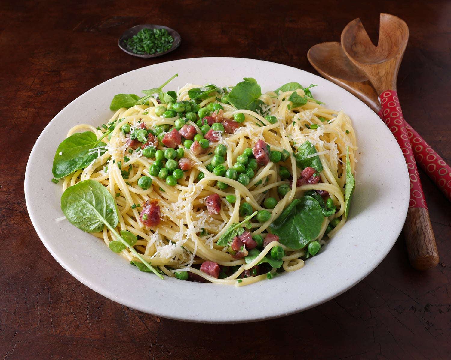 Pasta bowl filled with Carbonara with English peas and watercress.