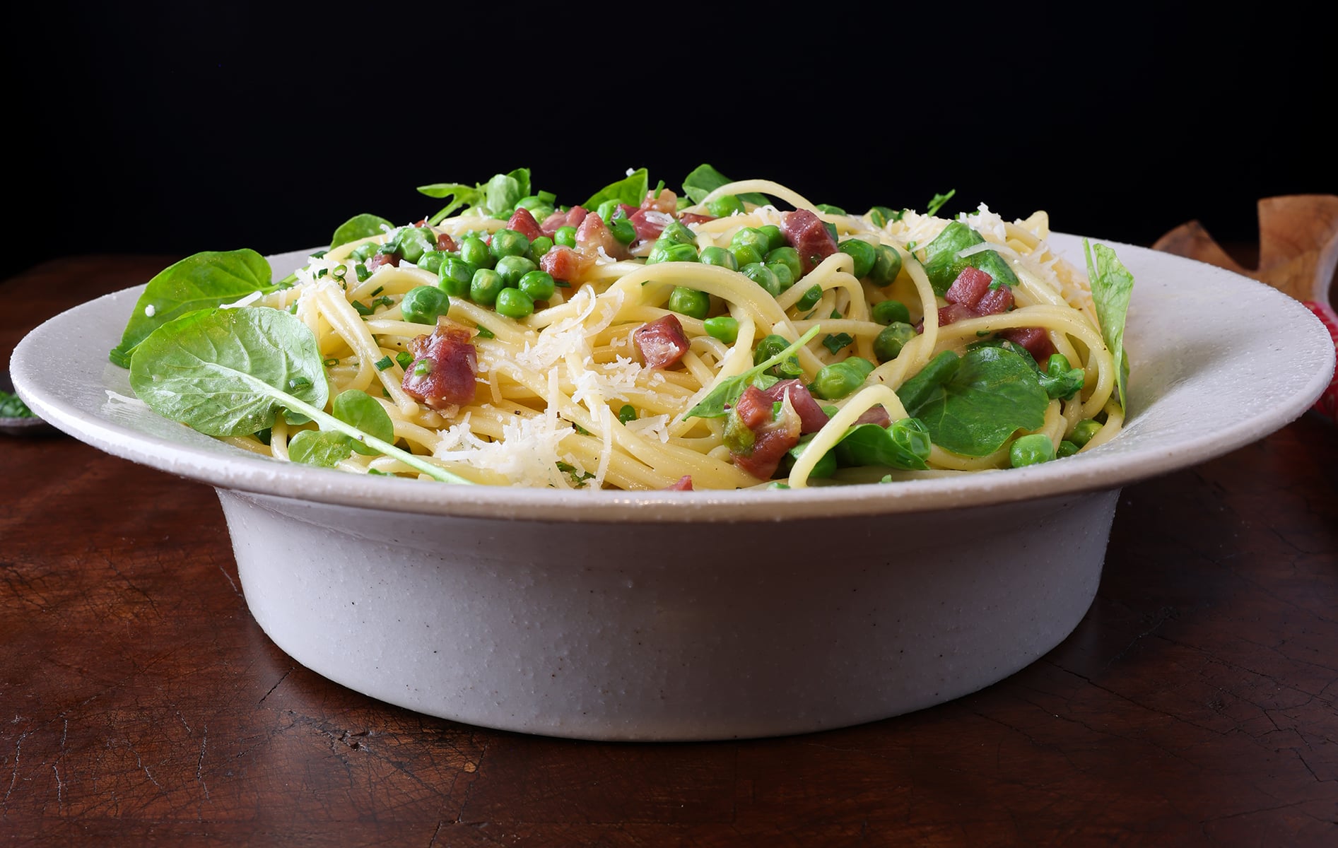 Deep pasta bowl served with Carbonara and English peas.