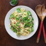 Top view of a pasta bowl with watercress and English peas over pasta Carbonara.