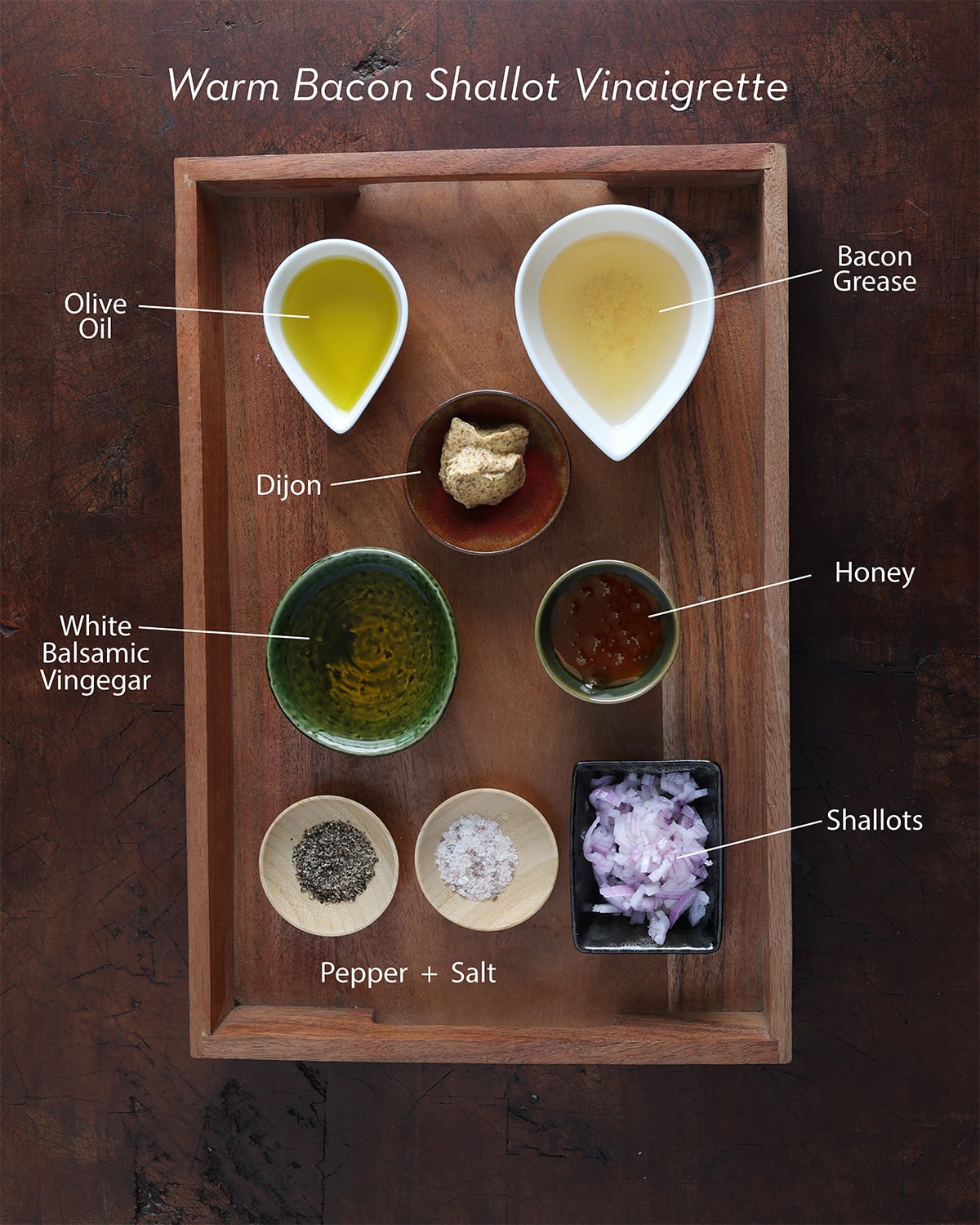 Ingredients measured and displayed that prepare a bacon shallot viniagrette.