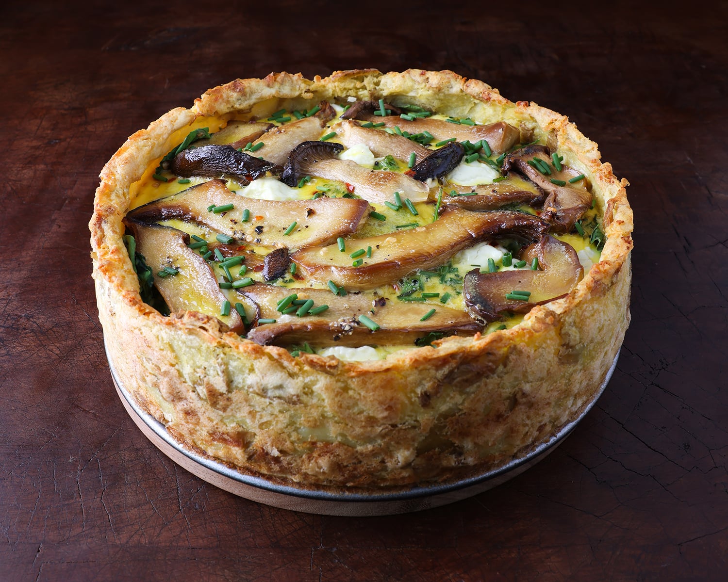 A crispy potato crust quiche made with king trumpet mushrooms and goat cheese