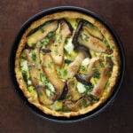 Top view of a potato crusted quiche with king trumpet mushrooms and goat cheese.