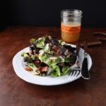 Freshly served dodo dinner salad on a plate with bacon and almonds.