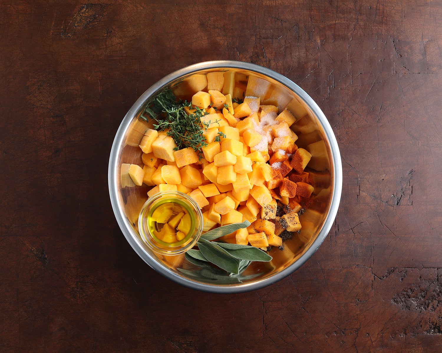 Ingredients to make mac and cheese with butternut squash added to a prep bowl before preparing the pasta dish.