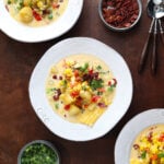 Baby potatoes, corn on the cob cut into the soup, bacon, veggies and green onions served in a bowl for the perfect creamy chowder.